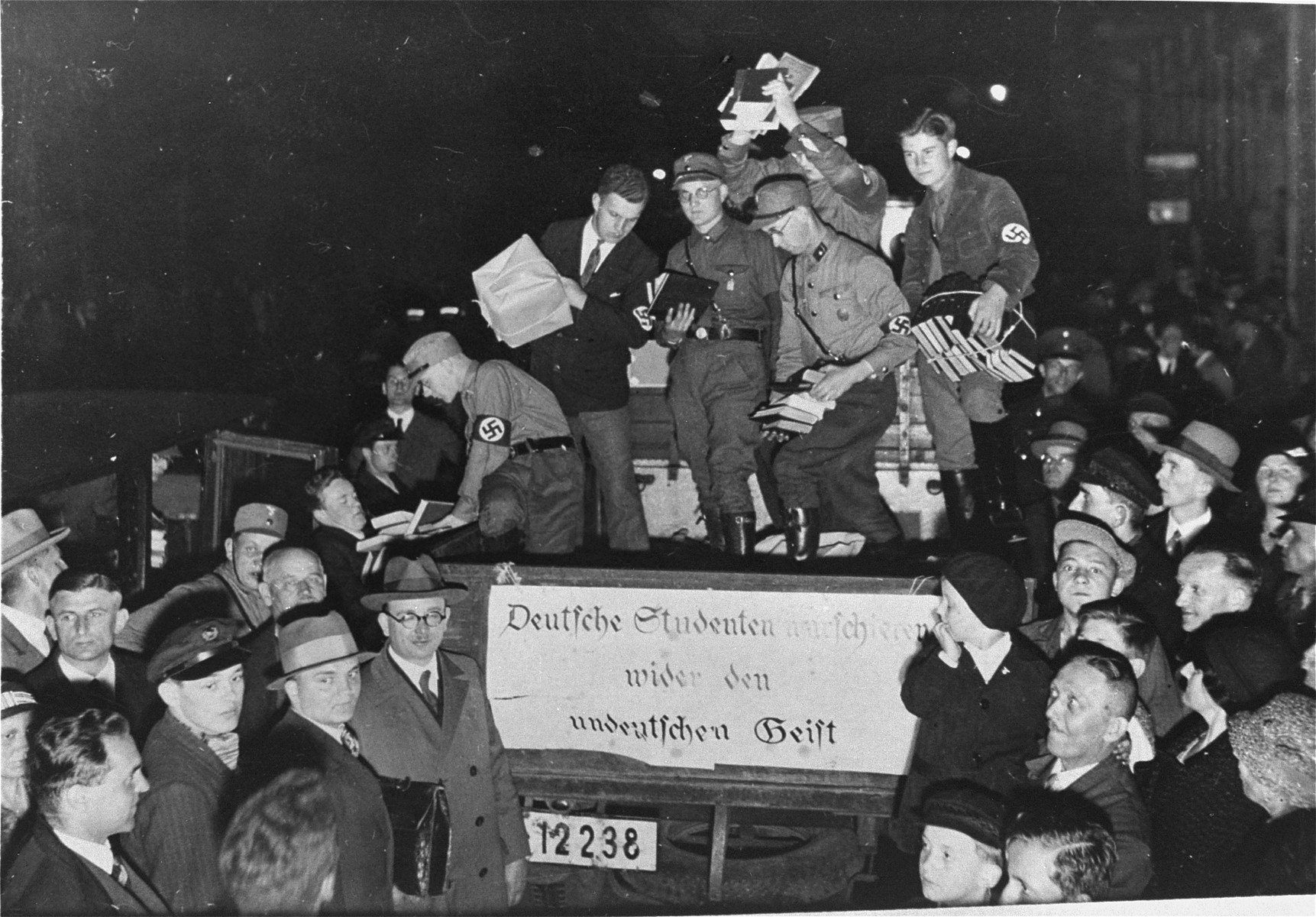 Nazi students unload confiscated materials for the public book burning that is to take place on the Opernplatz in Berlin.  The banner on the back of the truck reads: "German students march against the un-German spirit."