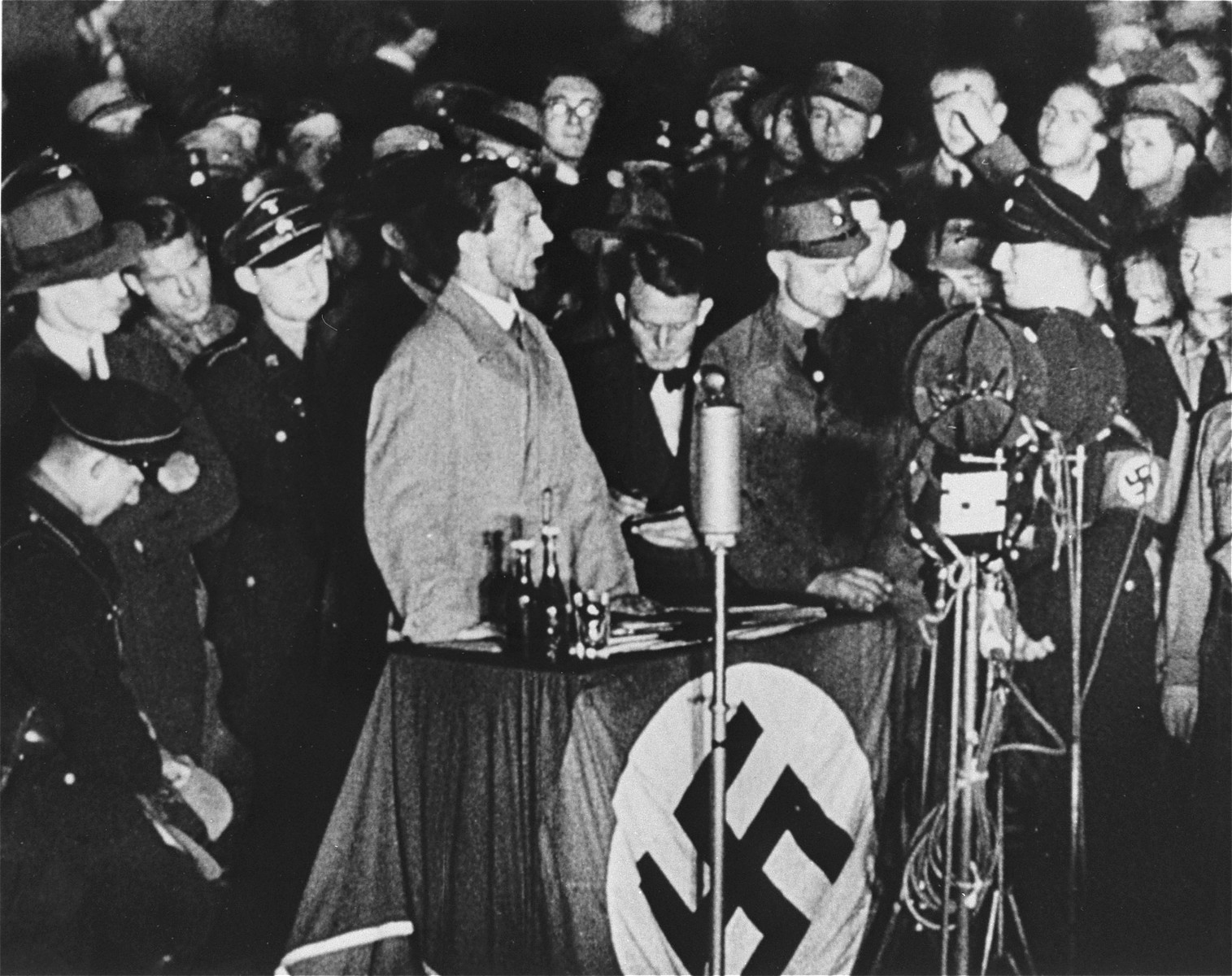 Reich Minister for Public Enlightenment and Propaganda, Joseph Goebbels, delivers a speech during the book burning on the Opernplatz in Berlin. 

Still from a motion picture.