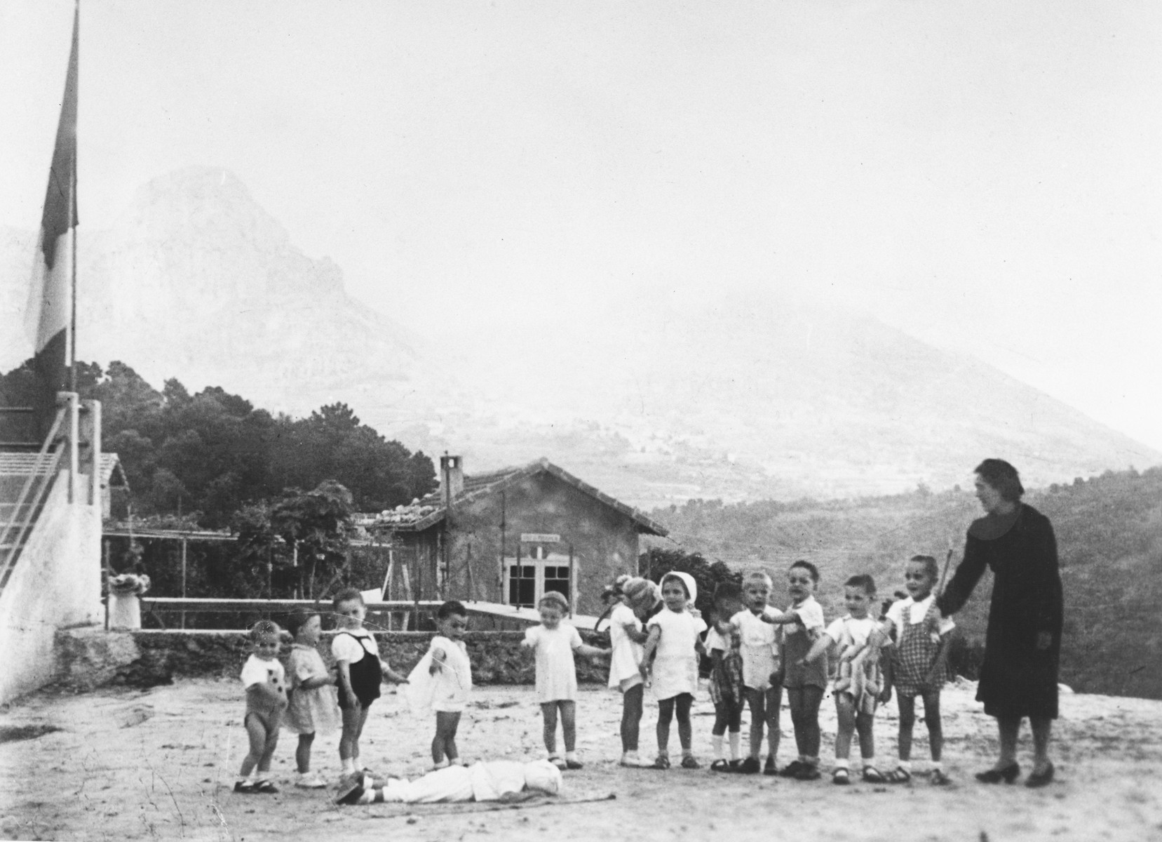 Miss Hermanova, a Czech Jewish nursery teacher, leads a circle game in the MACE children's home in Vence.