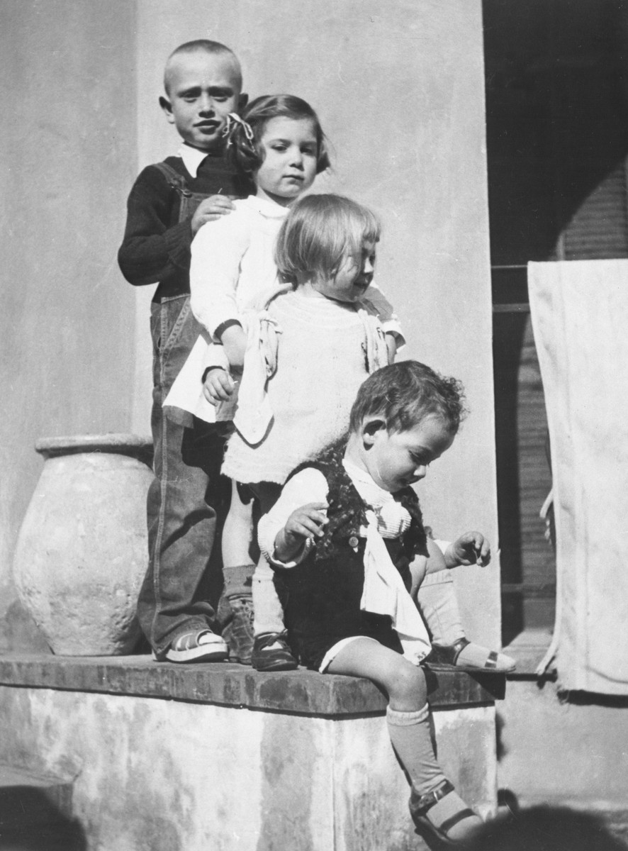 Four Jewish children stand in a row on the steps of the children's home in Vence.

In the back is Farkas and in front are three Mermelstein children.