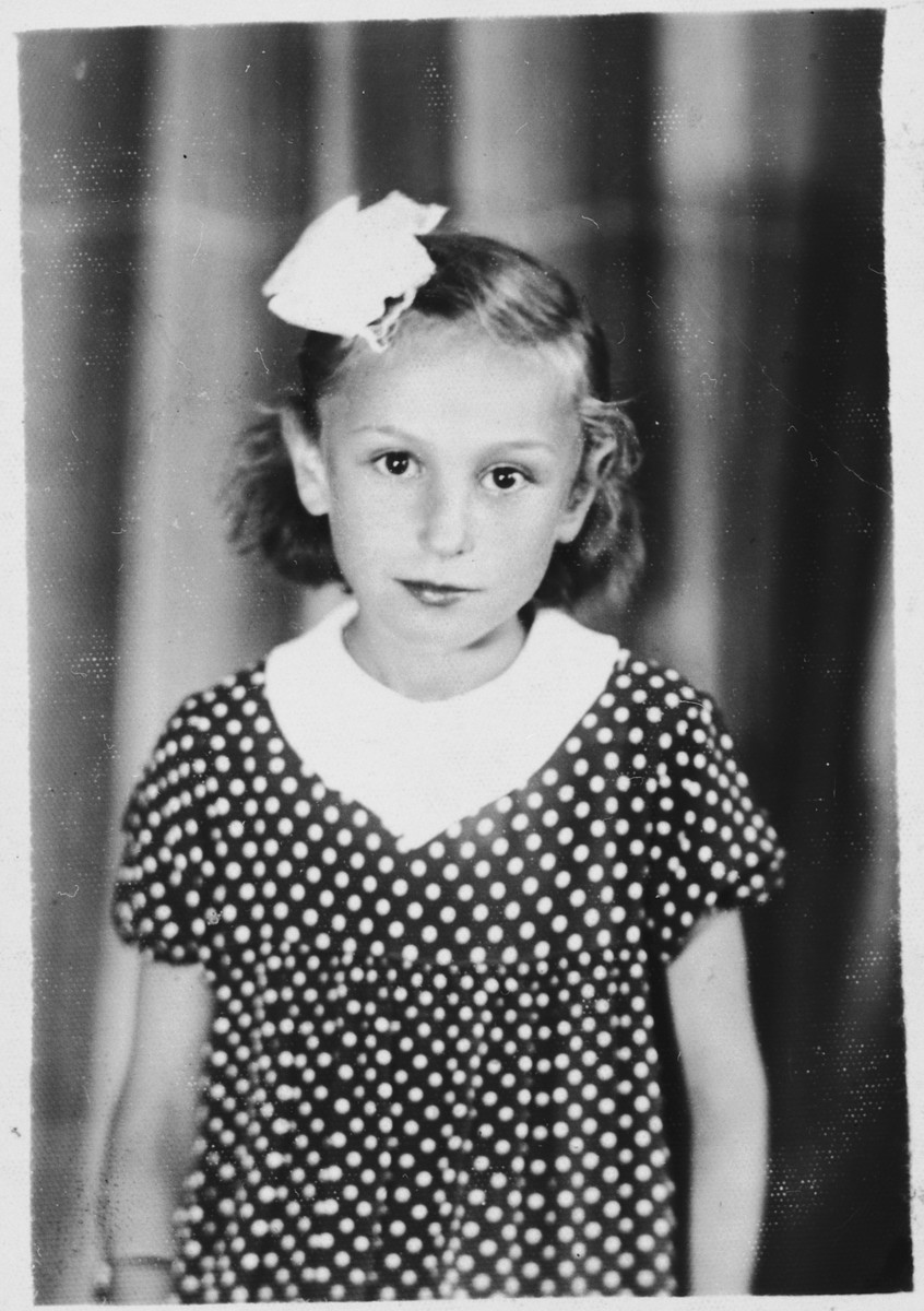 Studio portrait of a young Jewish girl wearing a bow in her hair in Bilki.

Pictured is Violet Mermelstein.