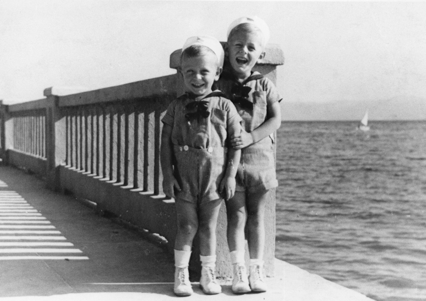 Two young Jewish brothers pose on a pier overlooking the Adriatic Sea in Crikvenica, Croatia, Augut 12, 1939.

Pictured are Branko (left) and Pavel (right) Deutsch.