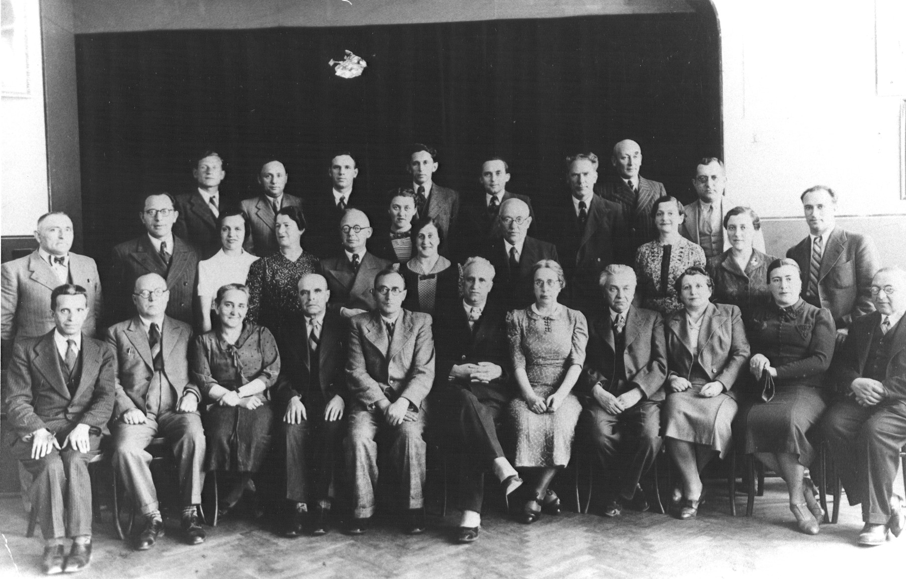 Group portrait of the faculty of the Hebrew Real Gymnasium in Kovno, Lithuania.

Seated in the center is the pricipal, front row (fifth from left) is the principal Dr. Kissin.  Standing in the top row on the far right is Shalom Tzvi Rachokovsky.