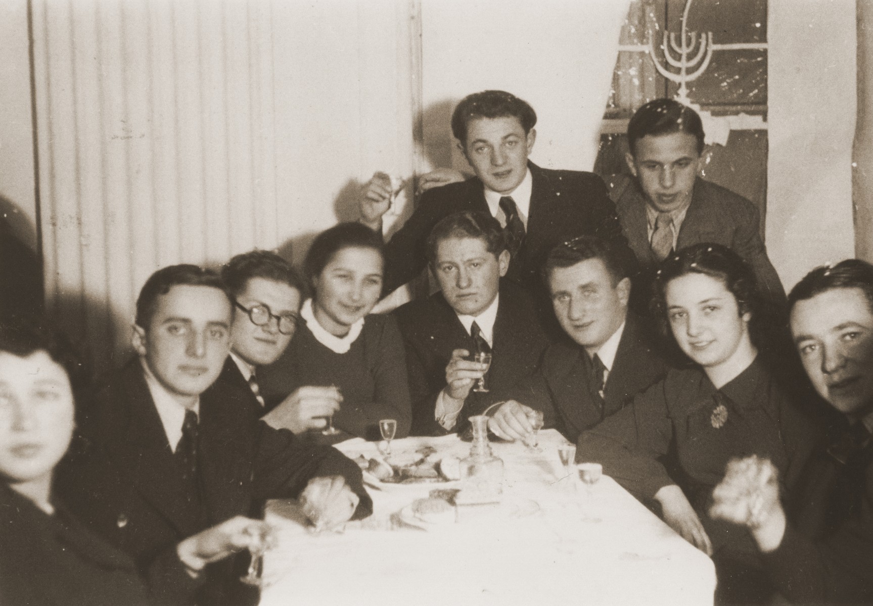 A group of Jewish friends gather in a private home for a farewell party for Rivka Radzinski prior to her departure for Palestine.

Rivka is pictured second from the right.  The photograph is inscribed to Rivka by her friend, Itzhak.