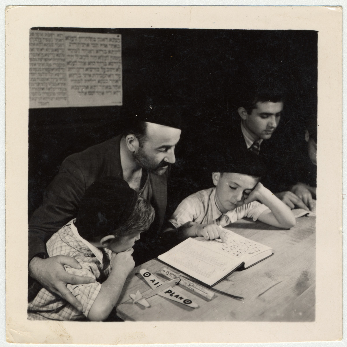 Buchenwald child survivor study a Hebrew text at an OSE (Oeuvre de Secours aux Enfants) children's home in France [either in Ambloy or Taverny].

Among those pictured is David Perelmutter who was born on January 8, 1937 in Lodz.