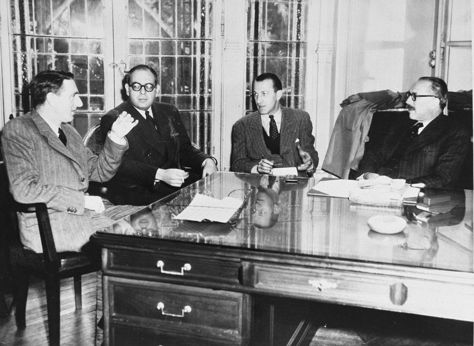 Leaders of the Jewish Agency for Palestine meet in the Paris office.  

Pictured from left to right are: Maurice Fisher, Paris representative of the political department of the Jewish Agency; Emile Nauar, Director of Political Information; A. Goldberg, Administrative Director; and Marc Jarblum, President of the Zionist Federation in France and delegate of the Jewish Agency in France.