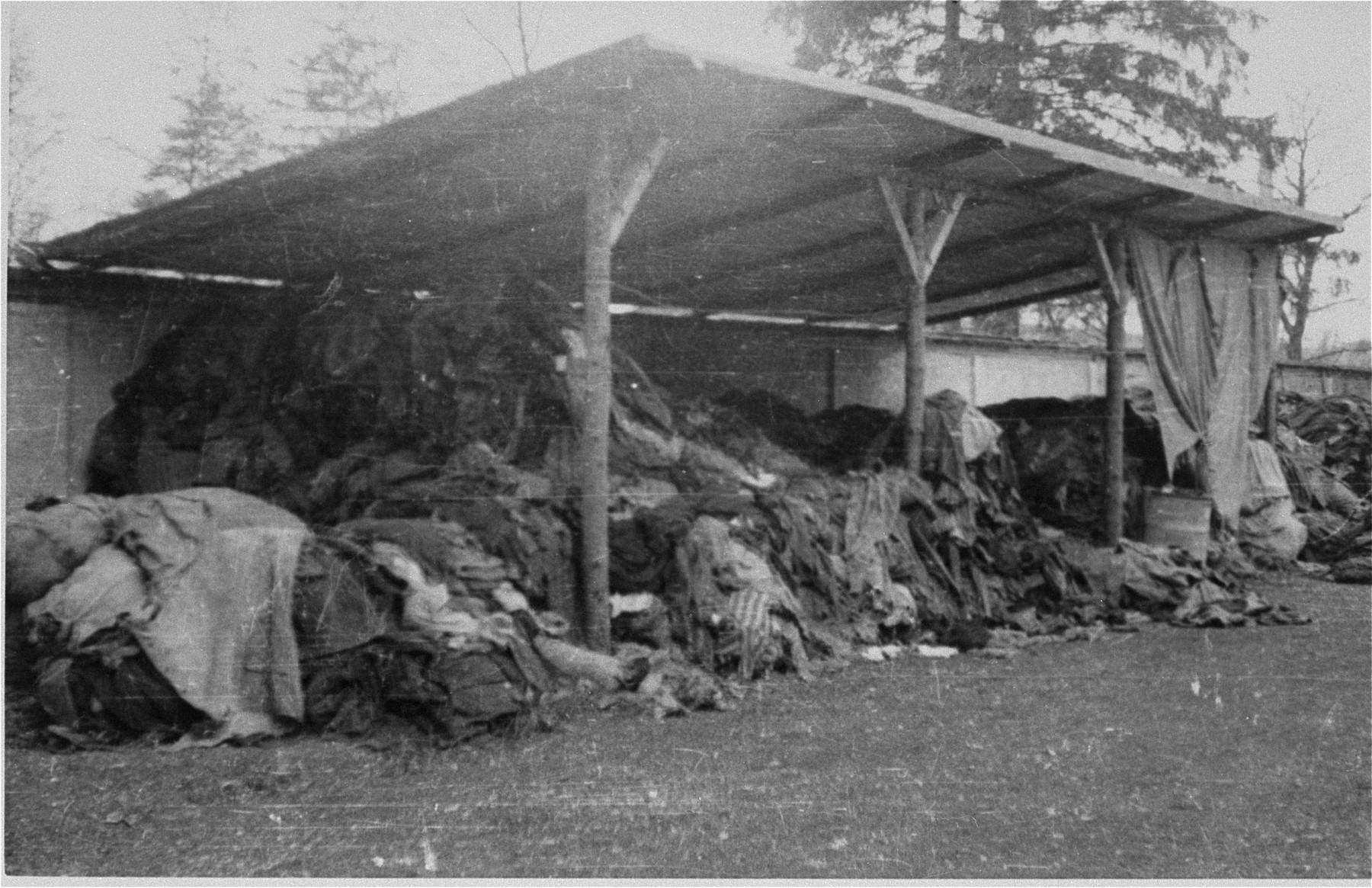 Prisoners clothing piled outside under an overhang.