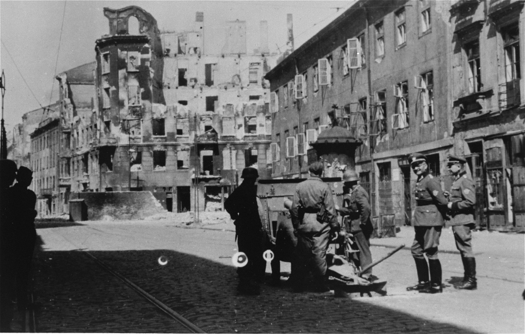 A German gun crew prepares to shell the ruins of a building during the suppression of the Warsaw ghetto uprising.
