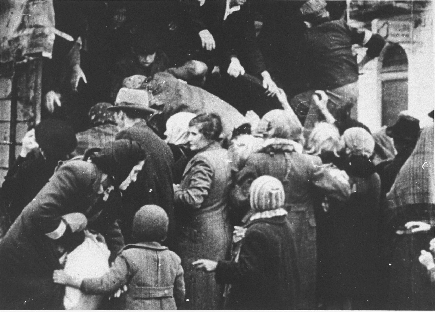 Jews captured by the SS during the suppression of the Warsaw ghetto uprising are forced to board a truck that will likely take them to a labor camp. 

Most of the people captured during the ghetto uprising were deported to Treblinka, however, some were sent to either Trawniki or Poniatowa.
