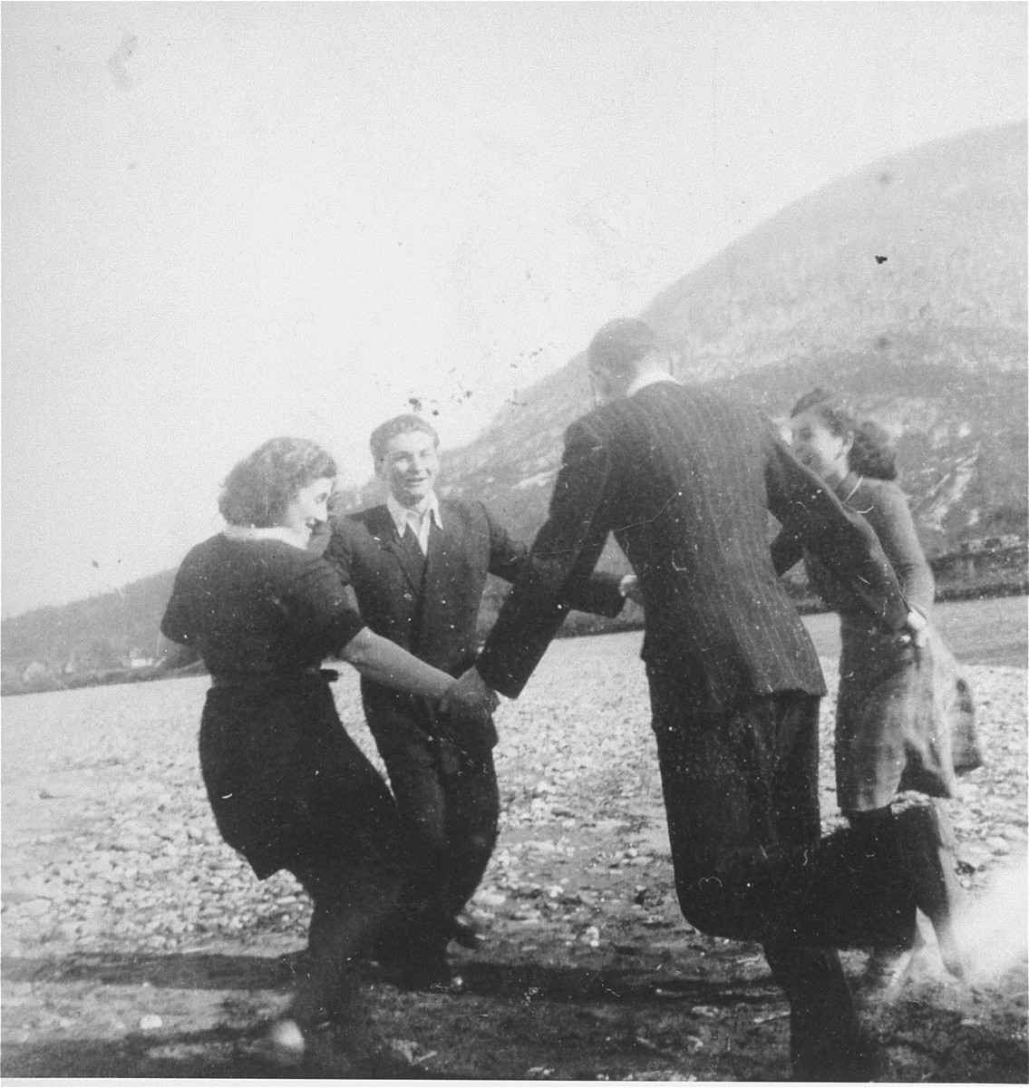 Members of the Hanoar Hatzioni Zionist youth movement in Tacovo, dance on the shore of the river Tissa.

Among those pictured are Frimet Ickovic.