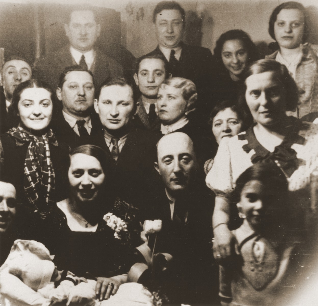 Group portrait of members of the extended Broda family at a gathering to celebrate the birth of the son of Aron and Sheindel Broda in Katowice.

Among those pictured are Aron and Sheindel Broda (front row, center), Tola and Salusia Goldblum (right) and Nacha Broda.