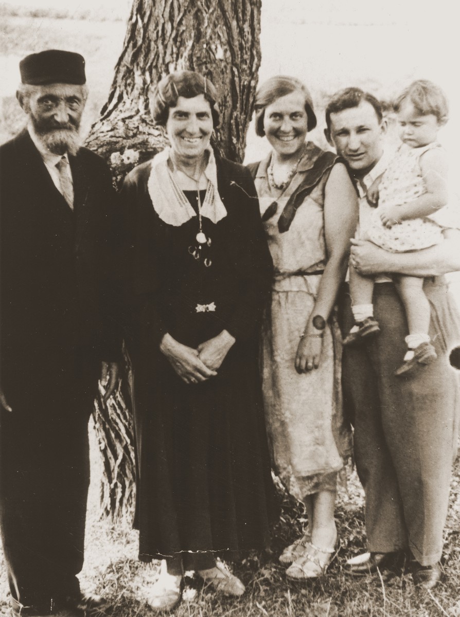 Members of the extended Broda family pose in front of a tree during a get-together in Zarki.

Pictured left to right are:  Berl and Hanna Gitel Broda and Tola, Izak and Salusia Goldblum.