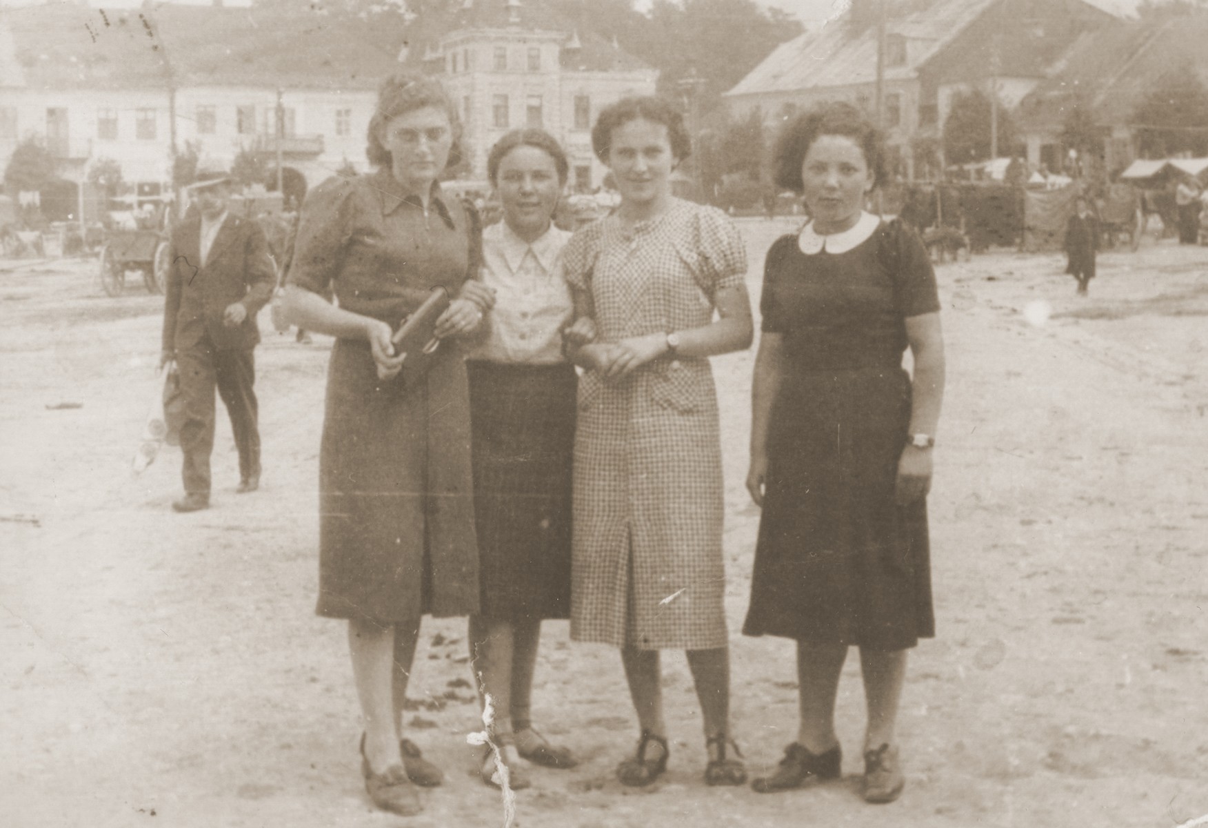 Group portrait of four young Jewish women in a public square in Lancut, Poland.

Pictured from left to right are: Ethel Ringelheim, Sheila Gurfein, Esther Amet and Basia Gurfein.
