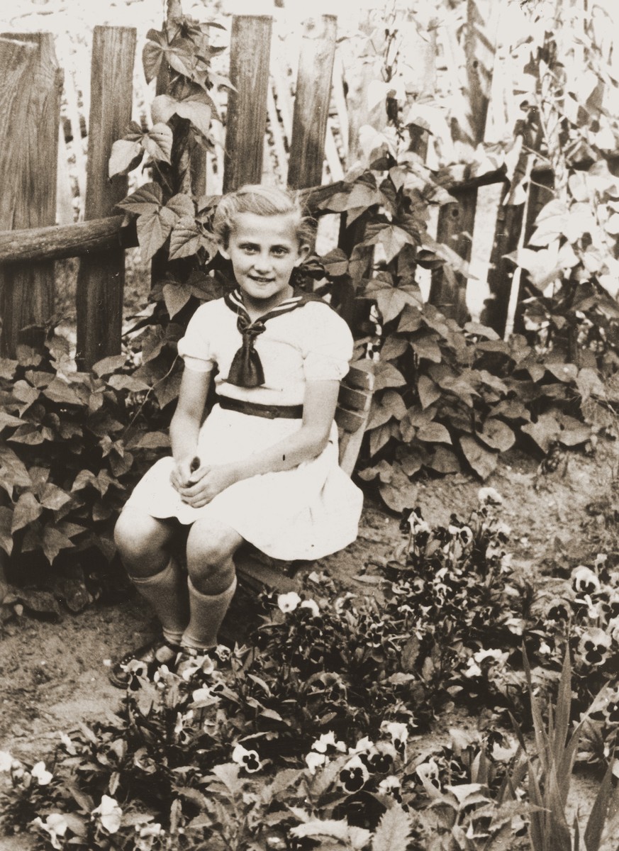 Seven year old Salusia poses in a garden in Zarki, where she was sent in the company of a Polish woman to check on the whereabouts of her grandparents.