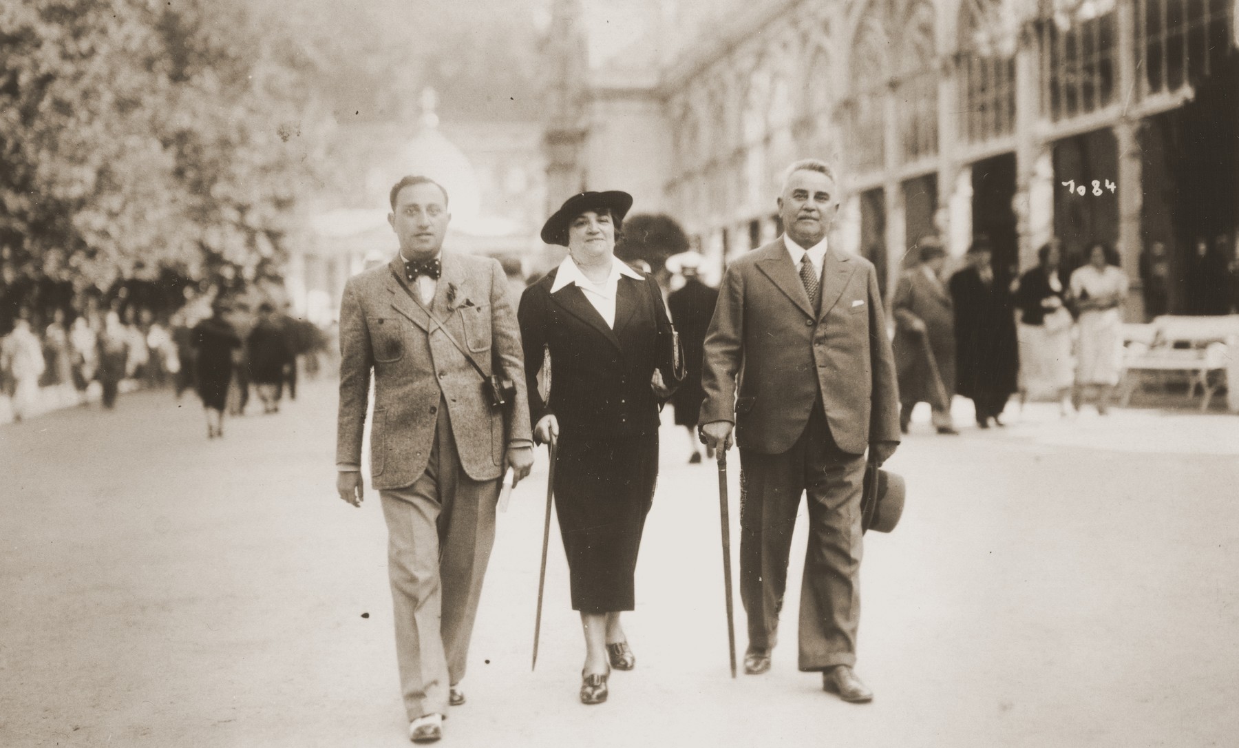 Two men and a woman walk along a street while on vacation in Marienbad, Czechoslovakia.

Julius Reinhold is pictured on the left.