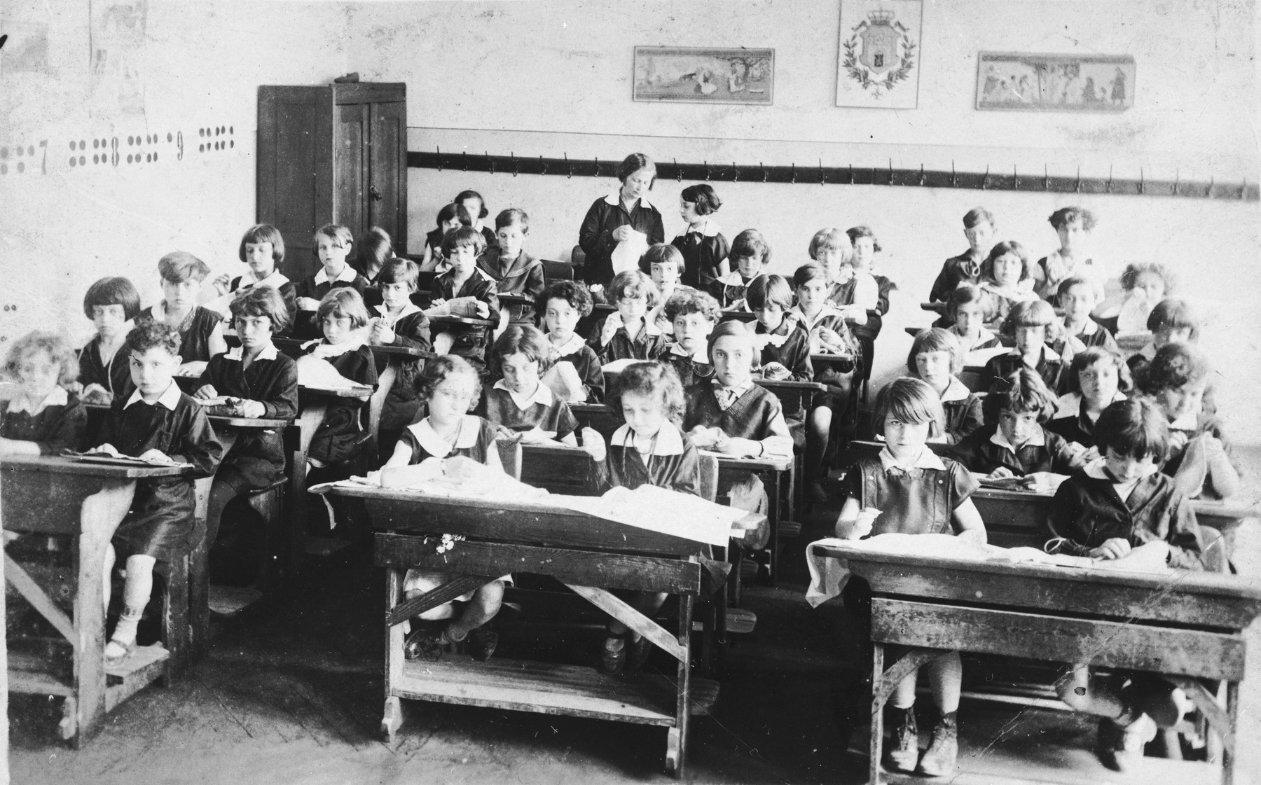 Pupils sit at their desks in a classroom at a public school on Zamarstynowska Street in Lvov.  The school, which was located in a Jewish neighborhood, was populated almost entirely by Jews.

Among those pictured is Tamara Abramowicz (lower left).