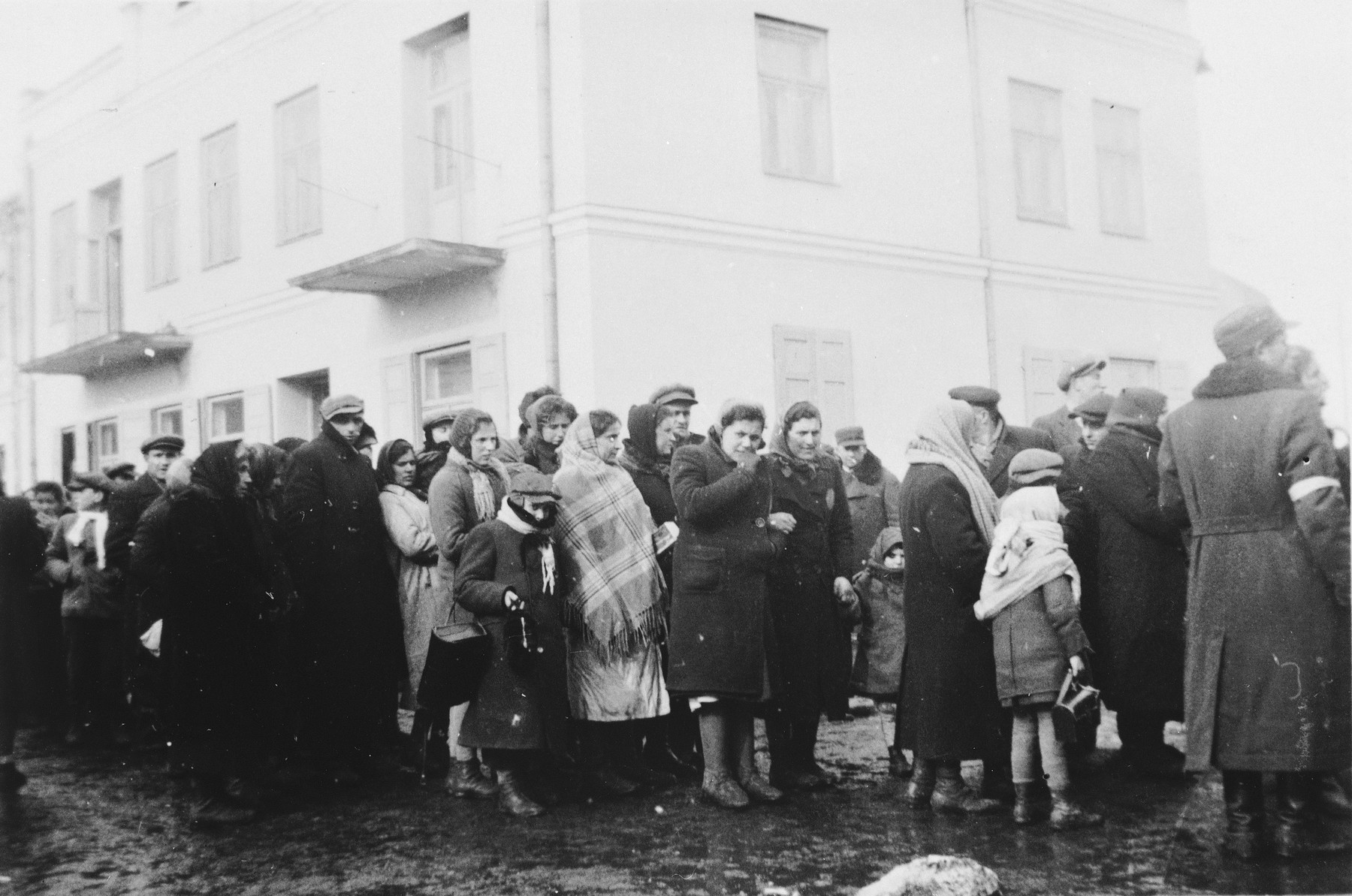Jews who have been expelled from the town of Plock, wait on a street to be resettled in Chmielnik.