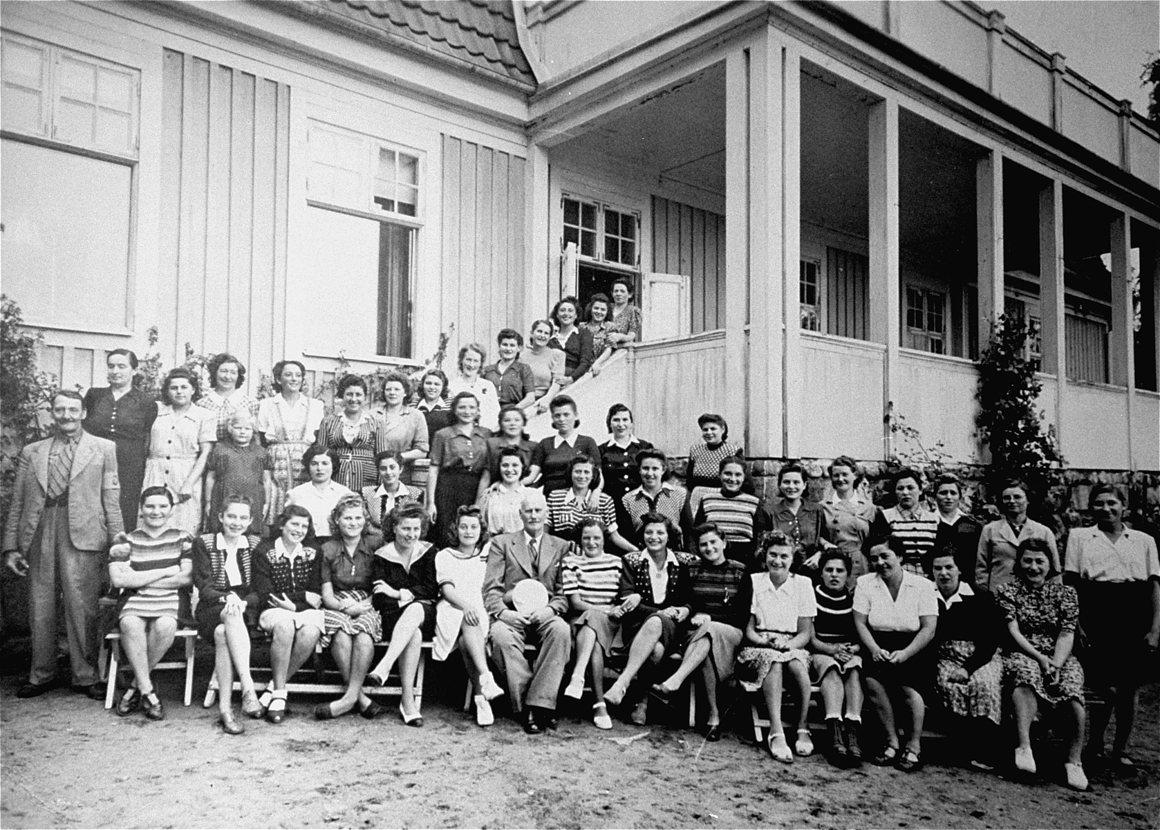 Group portrait of Jewish female survivors of Bergen-Belsen, who were evacuated to Sweden at the end of the war, and are now convalescing at hospital in Stensjoen Nomnekul.

Pictured in the back row, at the base of the stairs and seventh from the right, is the donor's wife, Helen Kaufman.  Originally from Beregasz, in Hungarian-controlled Slovakia, Kaufman was deported to Auschwitz in May 1944.  She was later transferred to Bergen-Belsen, where she was liberated.

Also among those pictured are Barbara (Borbala) Grunstein (third from the left in the front row) and her Ilona Gerendas (second from the left in the first row).