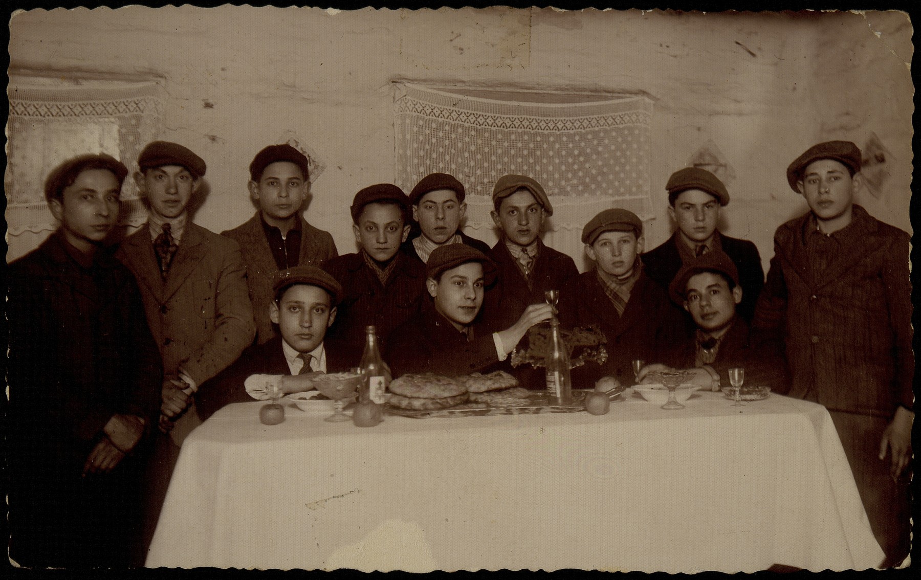 A group of boys gather around a dining room table for a party.

Fischl Shlanski is sitting at far right .