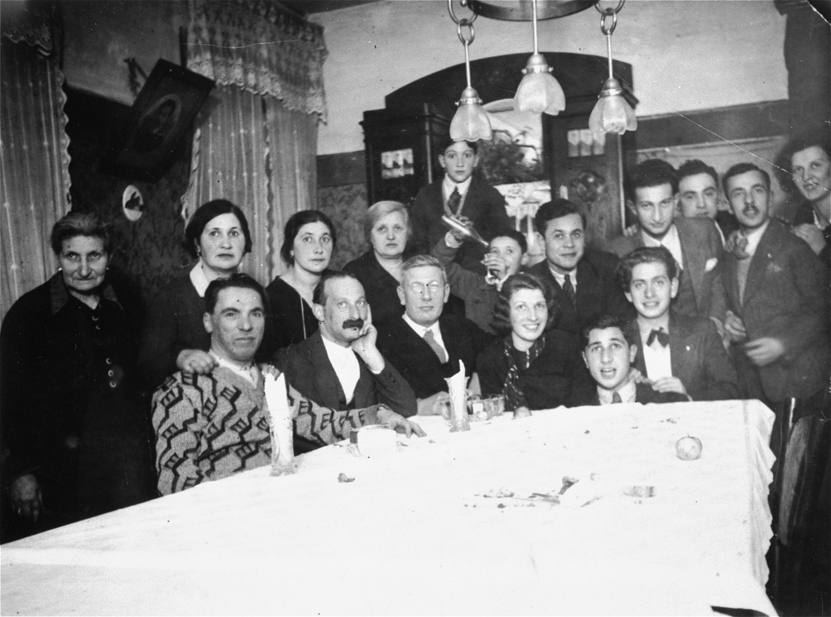 The Magid family at a house party in Vilna.  

Among those pictured are Raya, Boris and Genya Magid.  The donor, Genya Markon, is the granddaughter of Abram and Genya (Settel) Magid of Vilna.  The Magids had two daughters, Raya and Katia.  Raya Magid met Alexander Markon, a Jewish émigré living in France, while he was visiting his family in Vilna.  When Alexander returned to France, he and Raya carried on a courtship by mail, and the two were married in Paris on February 11, 1937.  In 1939, Alexander, who had served in the French army in 1927-1928, was recalled to the military.  Following his demobilization in the summer of 1940, he joined Raya, who had moved to Toulouse.  While waiting for permission to immigrate to the United States, she gave birth to their first child, Alain, on June 13, 1941.  In 1942 their visas arrived and they booked passage to the U.S. aboard the Portuguese liner Carvalho Araujo.  The ship left Lisbon in late October, arriving in Baltimore on November 2, 1942. Genya Magid died a natural death in Vilna in 1939.  With the German invasion of 1941 Abram and Katia were forced into the Vilna ghetto.  Abram was killed that same year during an action in Ponary.  Katia survived the concentration camps of Kaiserwald and Stutthof.