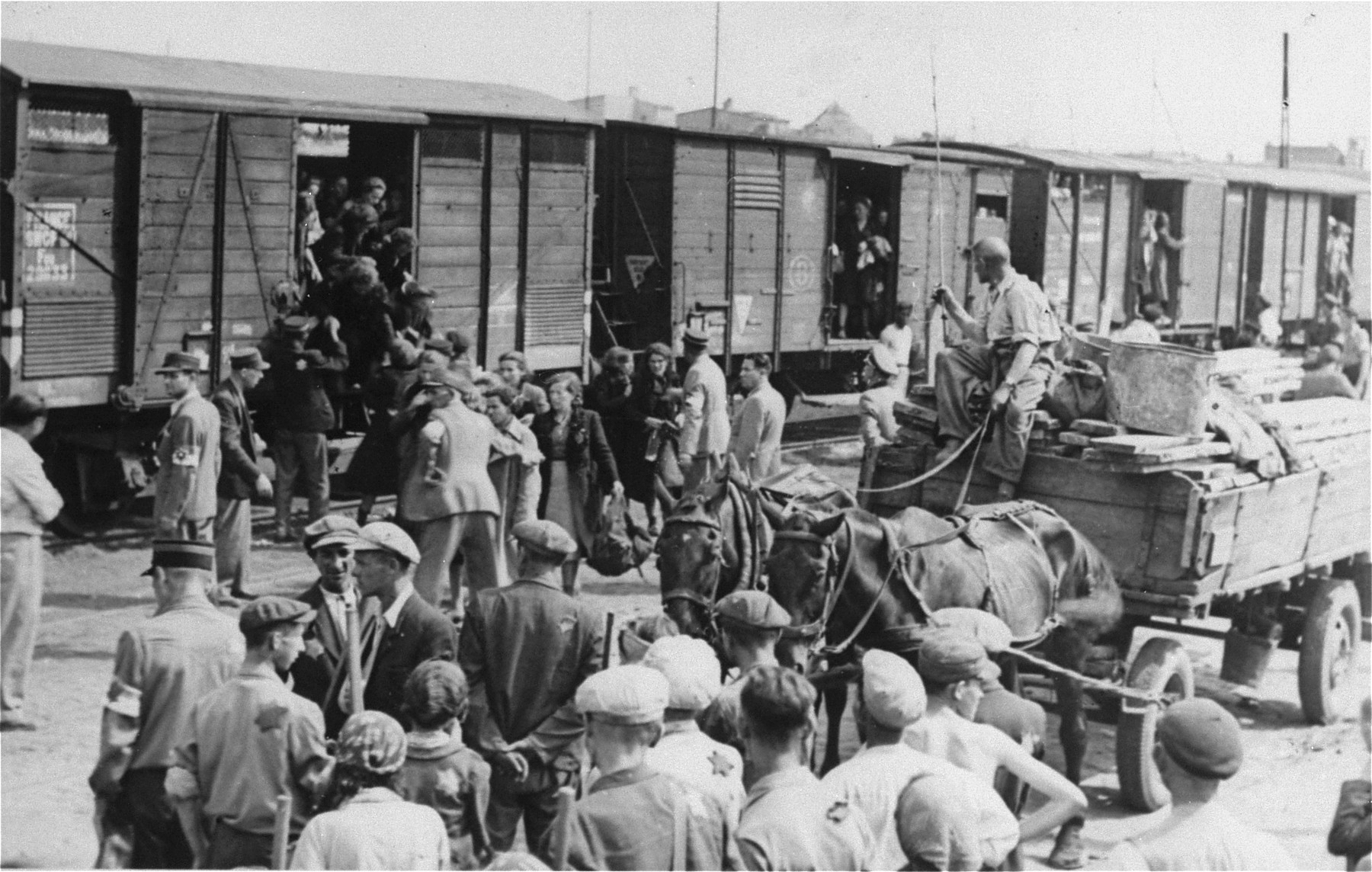 Jews from the Lodz ghetto board deportation trains for the Chelmno death camp.
