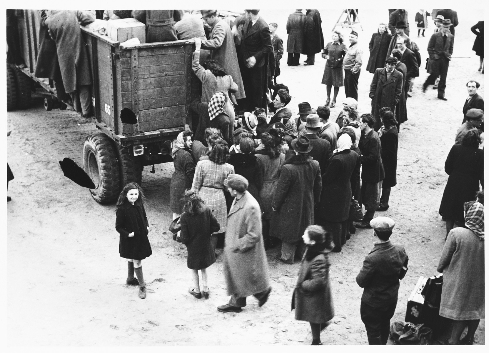Jewish DPs board open trucks during their departure from the Schlachtensee displaced persons camp.