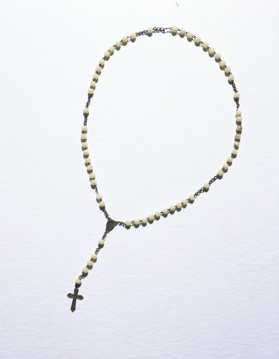 Rosary beads with a pendant crucifix given to the Jewish child, Lida Kleinman, while she was living in hiding in Poland during the German occupation.