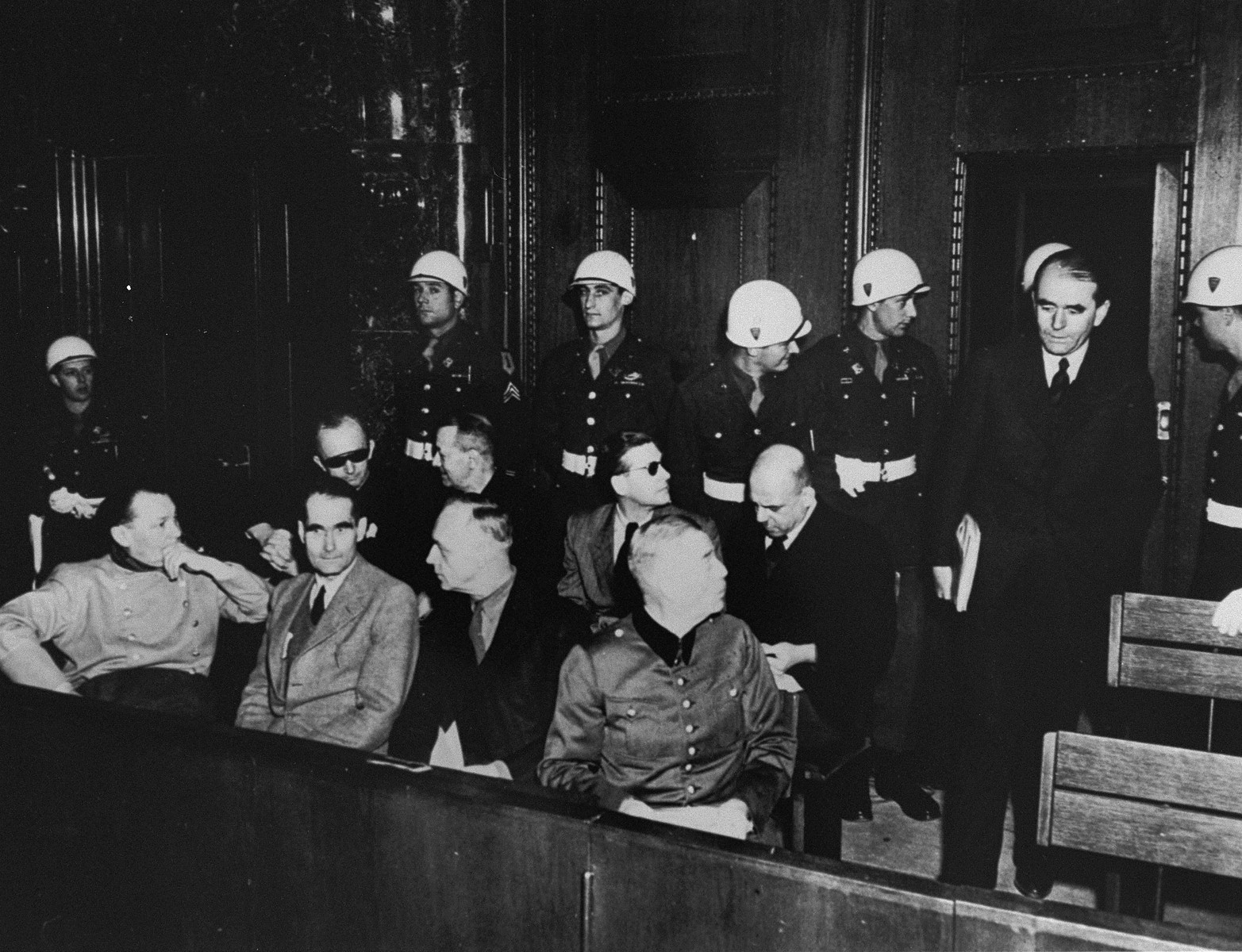 The defendants are led into the dock at the International Military Tribunal trial of war criminals at Nuremberg.

Pictured in the front row from left to right are: Hermann Goering, Rudolf Hess, Joachim von Ribbentrop and Wilhelm Keitel.  In the second row from left to right are: Karl Doenitz, Erich Raeder, Baldur von Schirach and Fritz Sauckel.