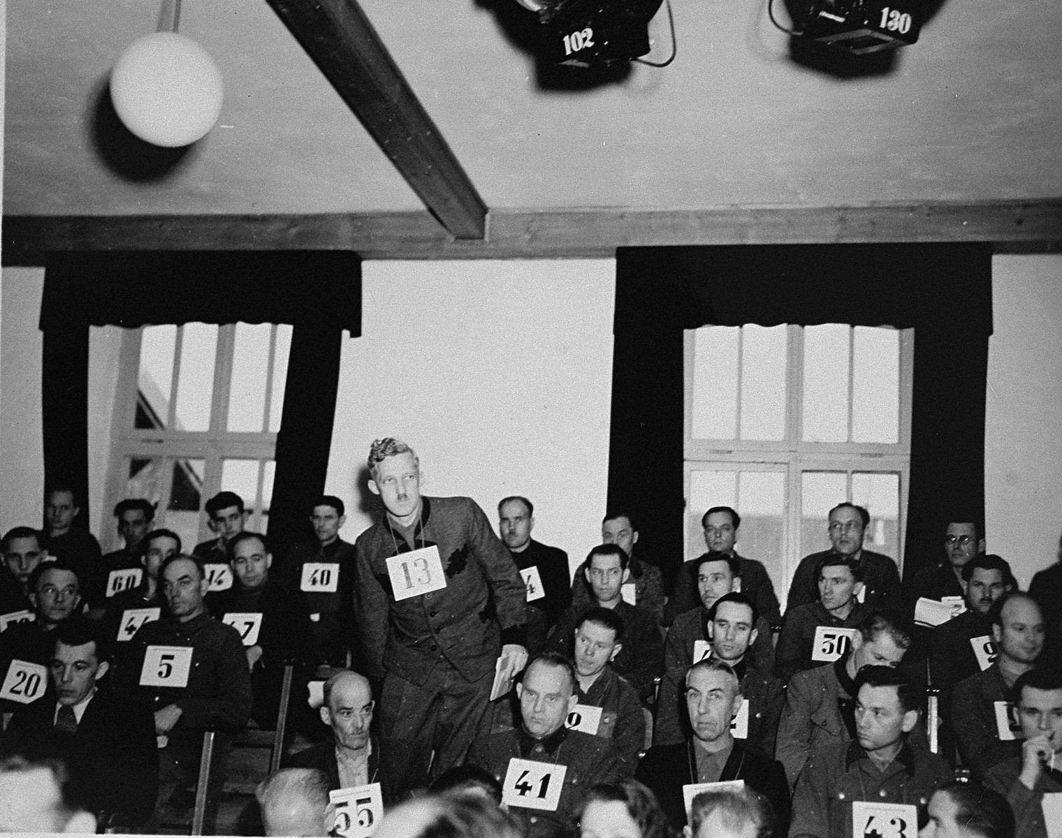 August Eigruber, former Gauleiter of Upper Austria and a defendant at the trial of 61 former camp personnel and prisoners from Mauthausen, stands up at his place in the defendants' dock.  

Eigruber was convicted and sentenced to death on May 13, 1946.