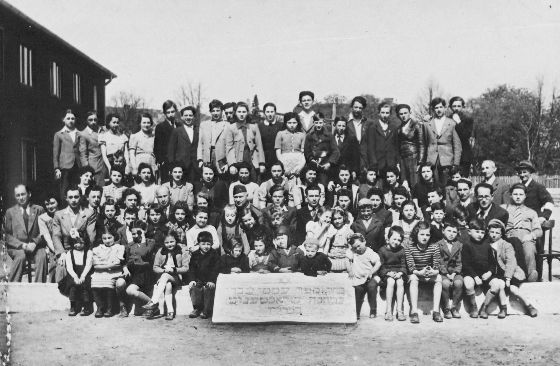 Group portrait of the students and teachers of the Hebrew primary school in the Schlachtensee displaced persons camp.  

Among those pictured is Harold Fishbein (third row from the front, center wearing the soft military cap) and Regina Laks (fourth row center).
