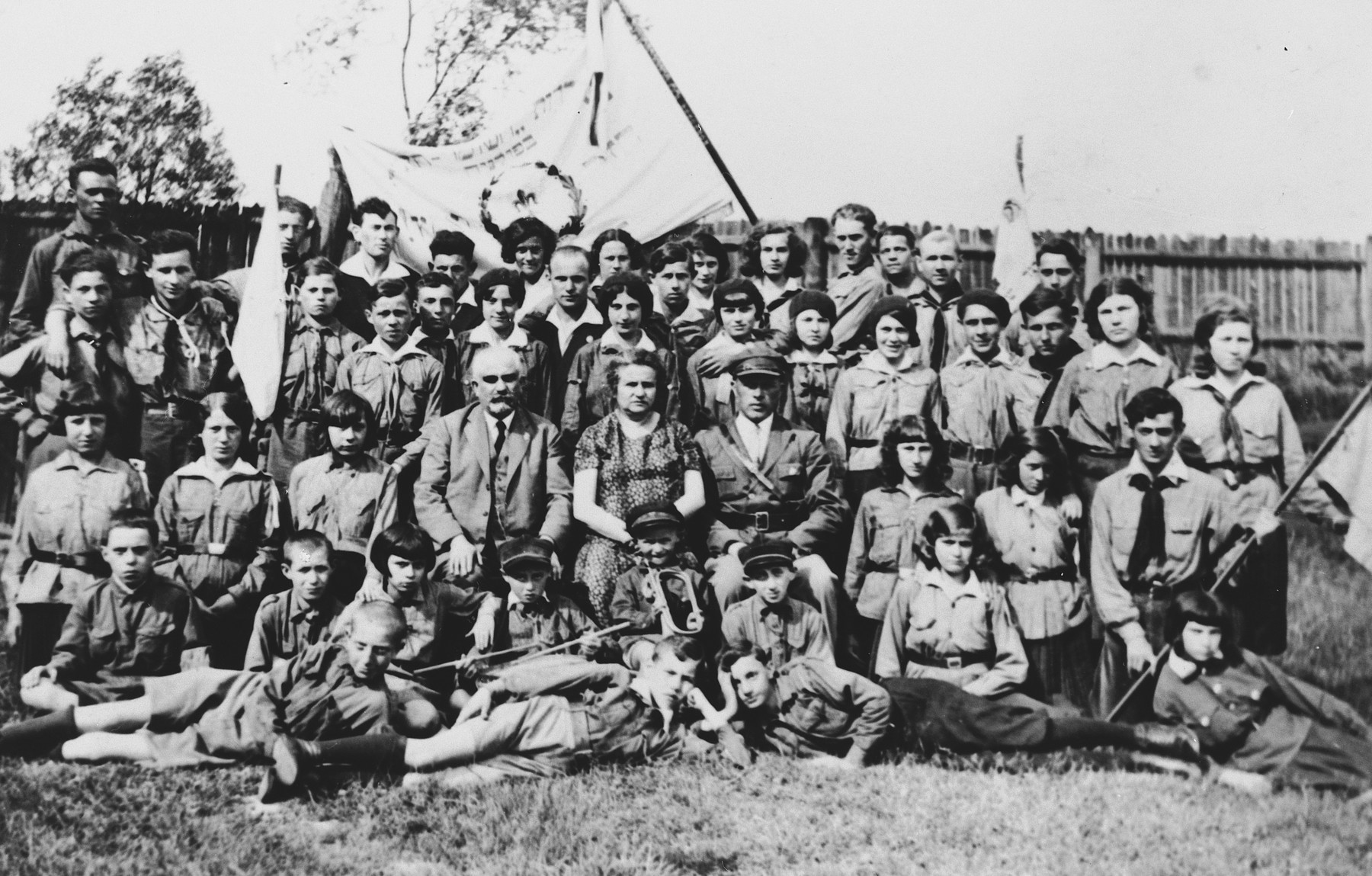 Children in a Zionist youth movement in Dabrowa Gornicza pose with flags and bugles.