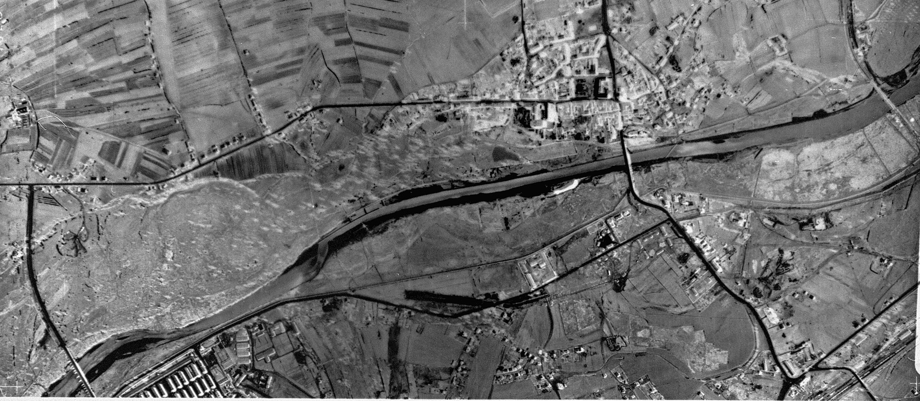 An aerial reconnaissance photograph of the Auschwitz area showing a small corner of  Auschwitz I .  The town of Oswiecim appears in the middle of the image.