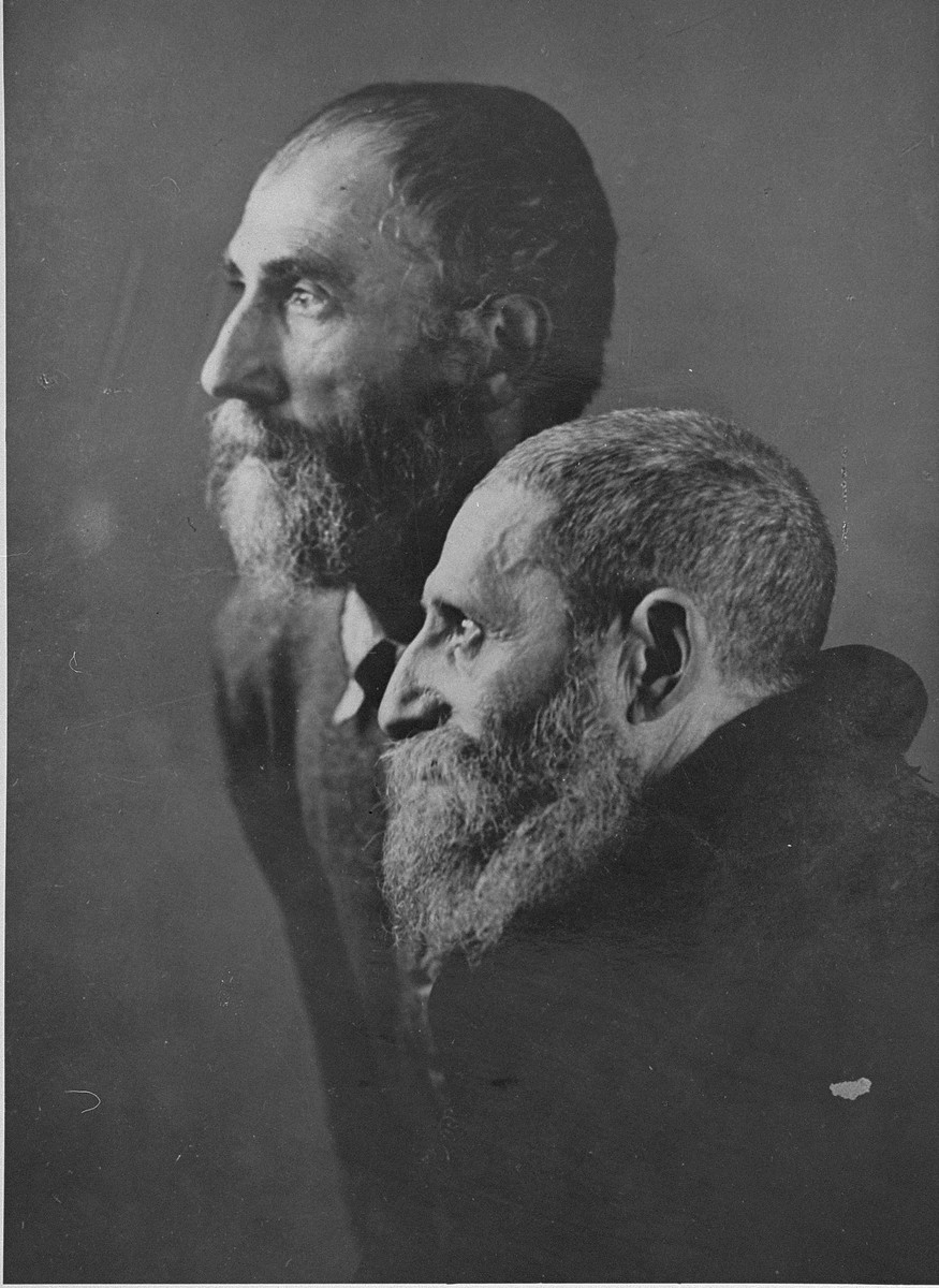 Portrait of two Jewish men from Subcarpathian Rus taken upon their arrival in Auschwitz-Birkenau. 

These two religious men were taken to the camp photographic laboratory in Block 26 to have their picture taken in order to document a certain "racial type".  They were later sent to the gas chambers, but not before they were humiliated by having to uncover their heads.