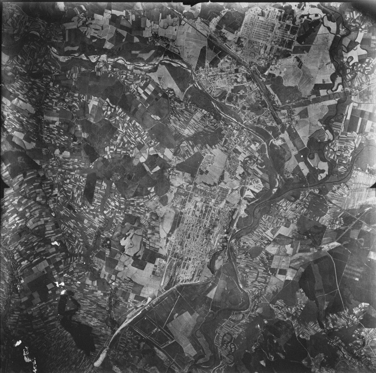 An aerial reconnaissance photograph of the Auschwitz area showing the three main camps , Auschwitz I, Auschwitz II (Birkenau), and Auschwitz III (Monowitz), as well as the I.G. Farben complex. The image demonstrates the relative size of the three camps.  [oversized photograph]

Mission:  60 PRS/462 60 SQ;  Scale: 1/54,000;  Focal Length: 6";  Altitude: 27,000'
