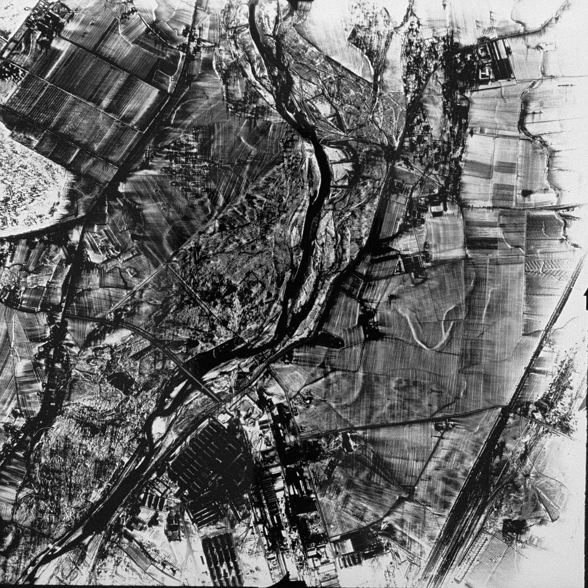 An aerial reconnaissance photograph showing Auschwitz I.  [oversized print]