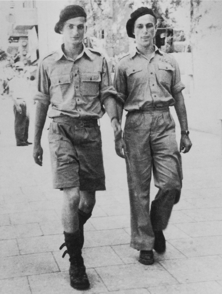 Former Exodus 1947 crew members Bernard Marks and Benjamin Forman, walk down a Tel Aviv street after making their first jump as Haganah paratroopers.