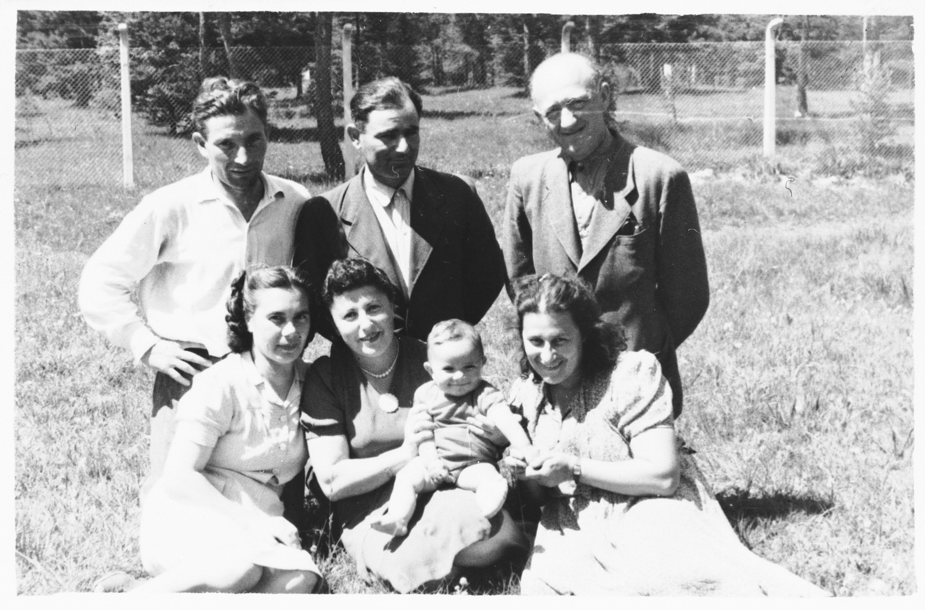 Three families pose together on a grassy field in the Foehrenwald ...