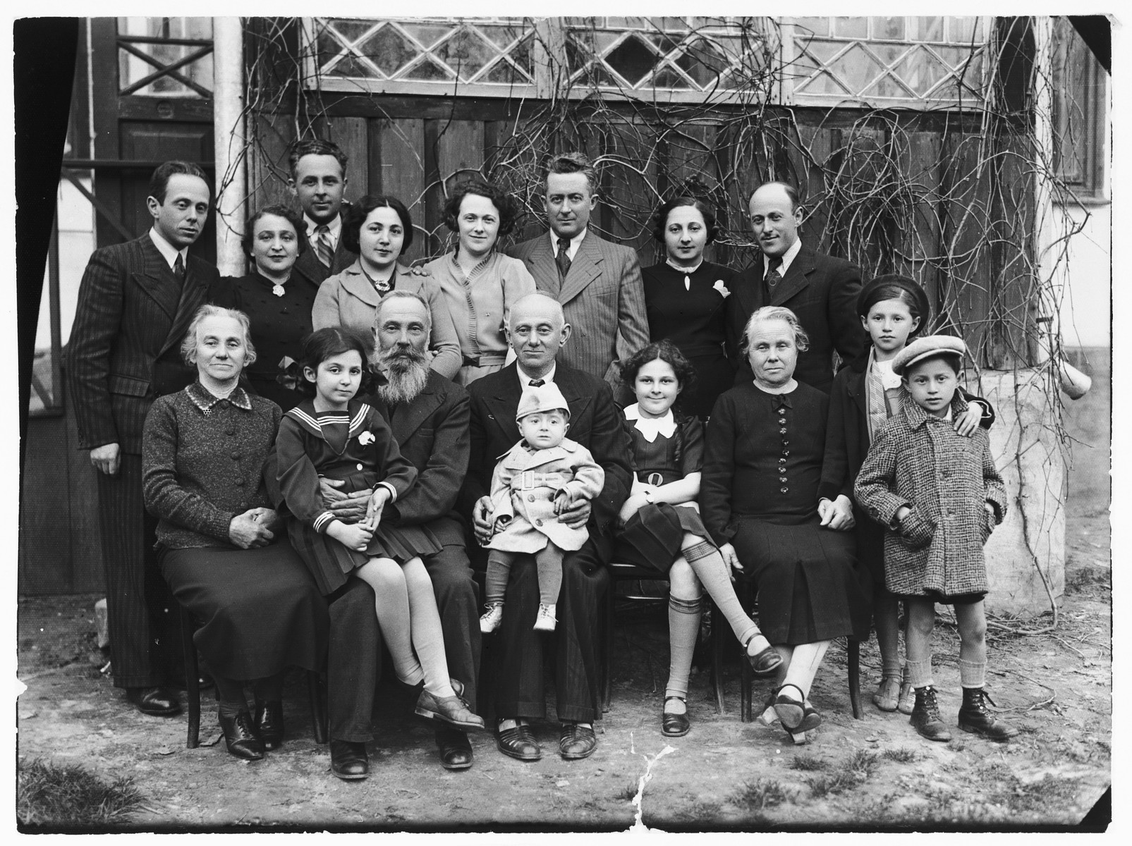 Portrait of the extended Sztejnsznajd and Gertner families taken on Passover shortly before the family of Josef Sztejnsznajd departed for America.

Pictured left to right.  Front row: Sara Teresz, Lila Garber, Uncle Avraham, Moshe Gertner, Chaim Sztejnsznajd, Sara Sztejnsznajd, Cipora Gertner, two Weinstein children.  Back row: Avraham Gertner, Baila Sztejnsznajd, Josef Sztejnsznajd, Peppa Garber, Goldie Sztejnsznajd, Czala Garber, Peppa Gertner, and Josef Gertner.