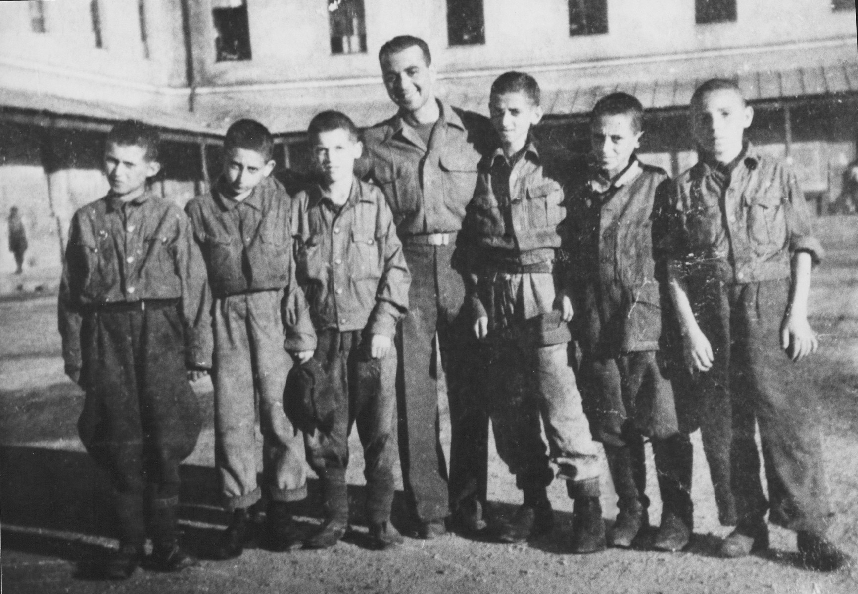 An American Jewish liberator poses with six children in the Gunskirchen concentration camp.

Pictured in the center is Max Wolfson.  Meir Gecht is one of the children.