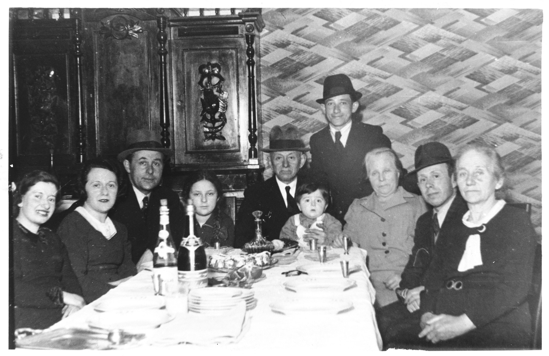 The Sztejnsznajd family celebrates its last seder in Luck prior to departing for America.

From right to left: a great-aunt, Avraham Gertner, Cipora Gertner, Yankel, Chaim Sztejnsznajd, Moshe Gertner, Sara Sztejnsznajd, Josef Sztejnsznajd, Goldie Sztejnsznajd, and a cousin also named Goldie.