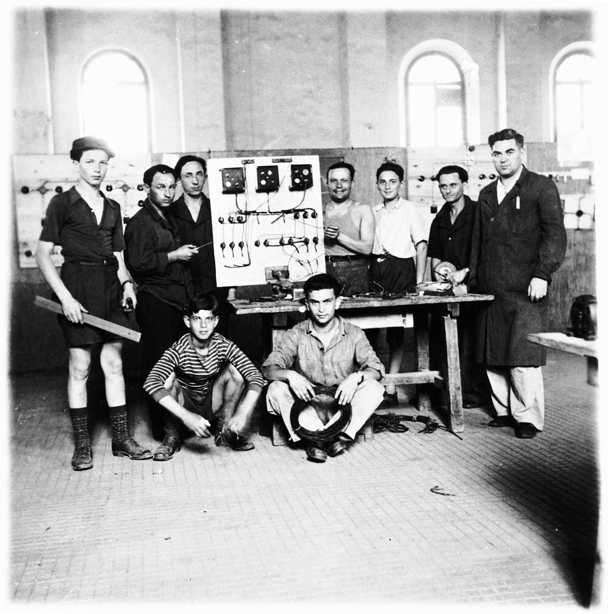 Jewish teenagers attend a vocational ORT school in the Cremona DP camp.

Shie Zoltak is standing on the far left.  The instructor (Shie's uncle) Abraham Lisogurski is standing on the right.