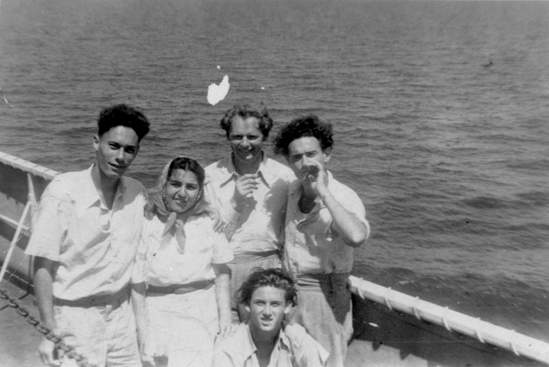 John Stanley Grauel poses on the deck of the SS Marine Carp with friends and fellow journalists, while on his way back to the United States after serving on the crew of the Exodus 1947.