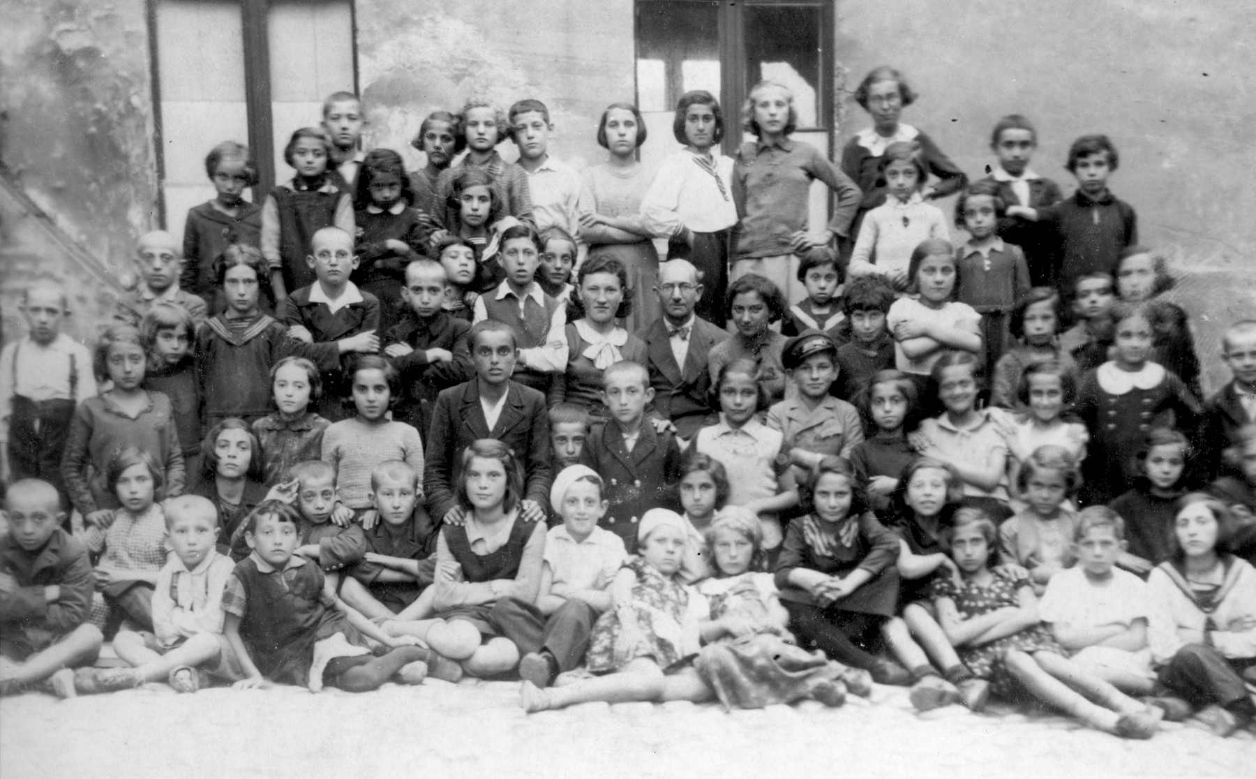 Group portrait of children at a summer day camp in Bedzin.  

Among those pictured is Abram Szyjewicz (first row, center, wearing a light shirt and beret) and his sister Laja (not identified).