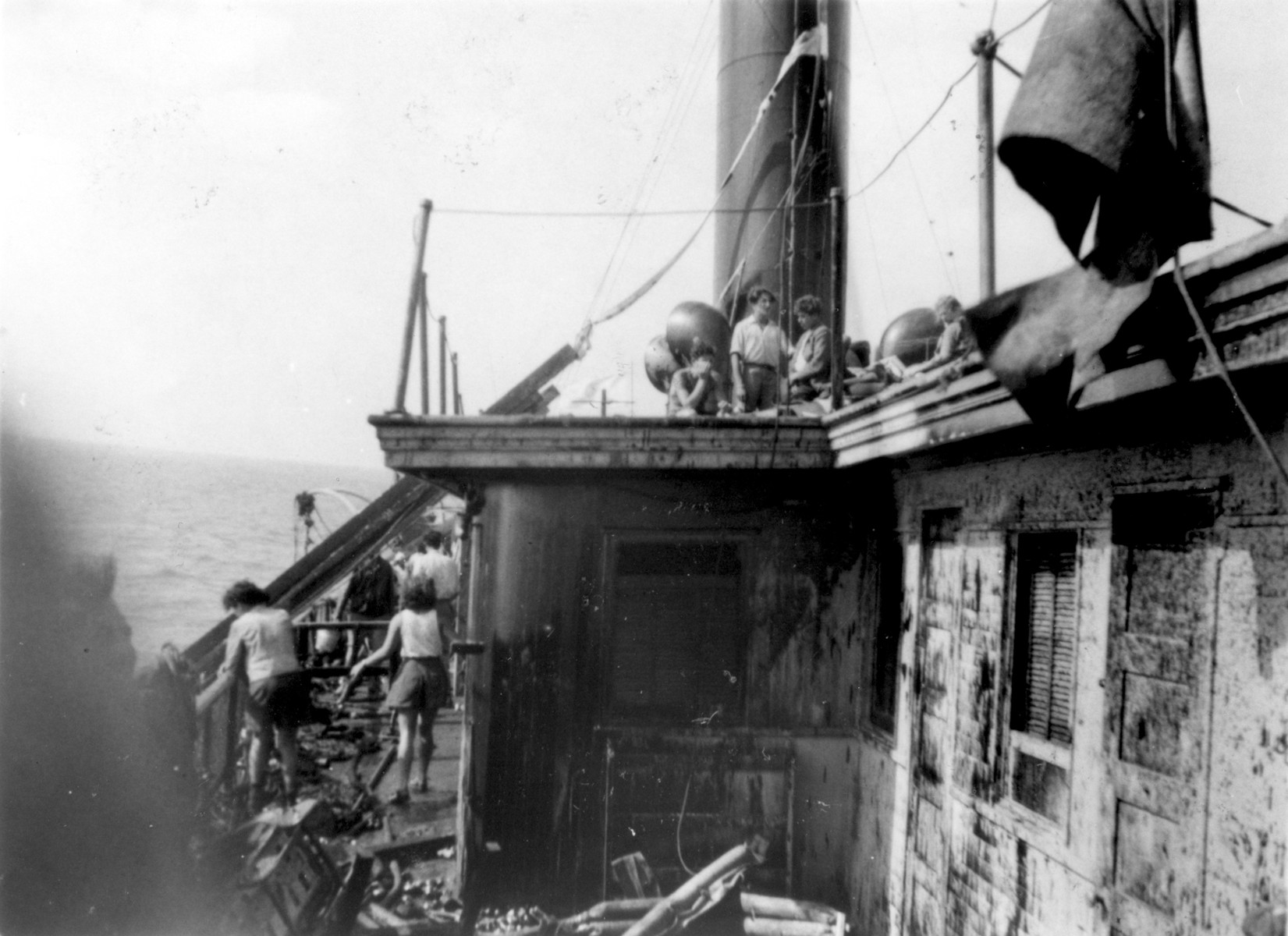 Exodus 1947 passengers survey the damage the morning after the battle with the British boarding party.