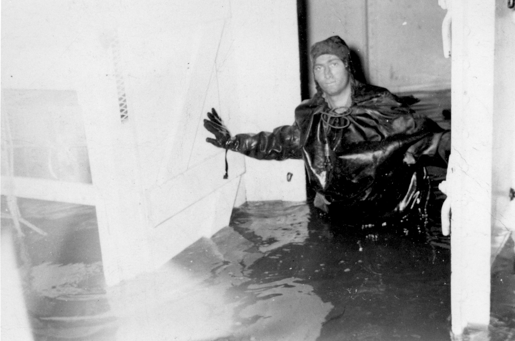 Murray Aronoff stands knee-deep in water in the engine room of the President Warfield after the gale that nearly sank the ship during its first attempt to cross the Atlantic Ocean.