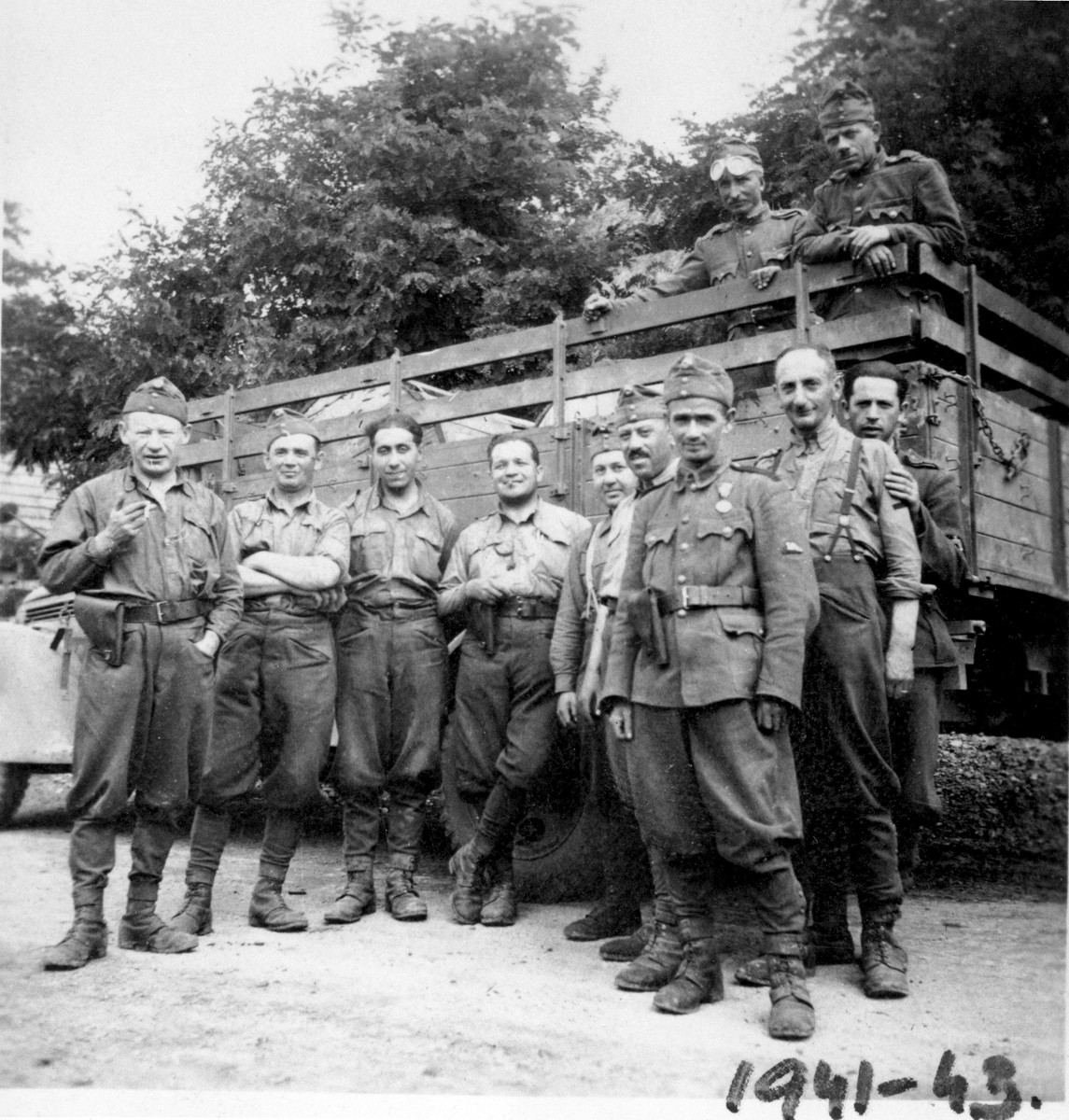 A unit of Hungarian soldiers that includes a Jew from Budapest, poses in front of a truck.

Among those pictured is Gyula Spitz (second from the left).