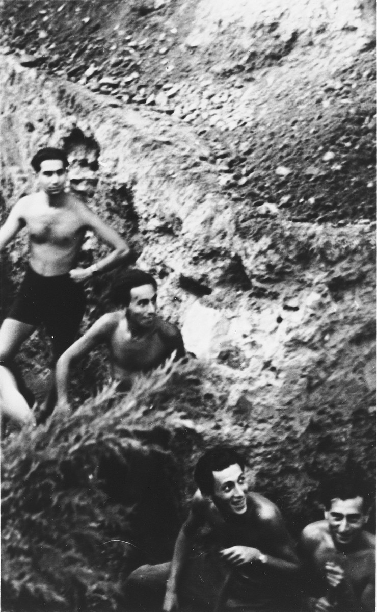 Four Slovak Jews pose on a stony hill in the Zilina labor camp.

Fritz Bruck is standing at the top left.  Kiki Danzig is in the center.  Max Stern is at the lower left.  The photograph was taken by Manfred Hirsch, a German friend who had come to visit.