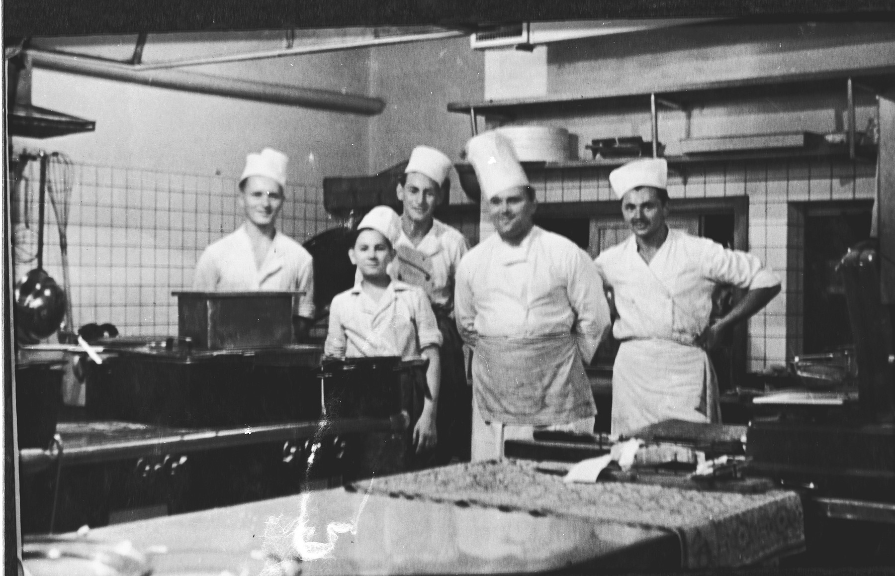 Group portrait of cooks in a kitchen in Prague during the Nazi occupation.

Among those pictured is Edgar Krasa, who was working as an apprentice chef.