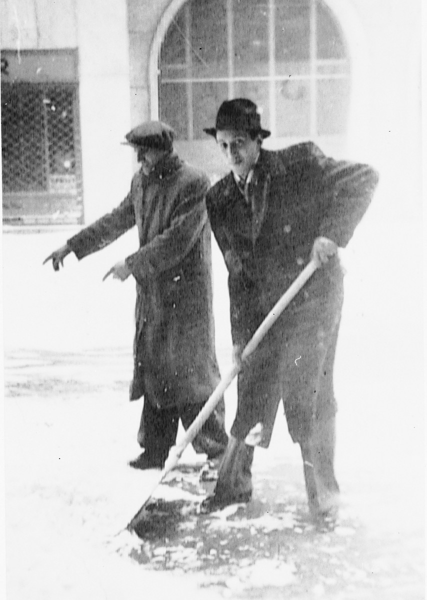 Max Stern is forced to shovel snow under the direction of a Slovak guard.

The photograph was taken by a German friend, Manfred Hirsch.