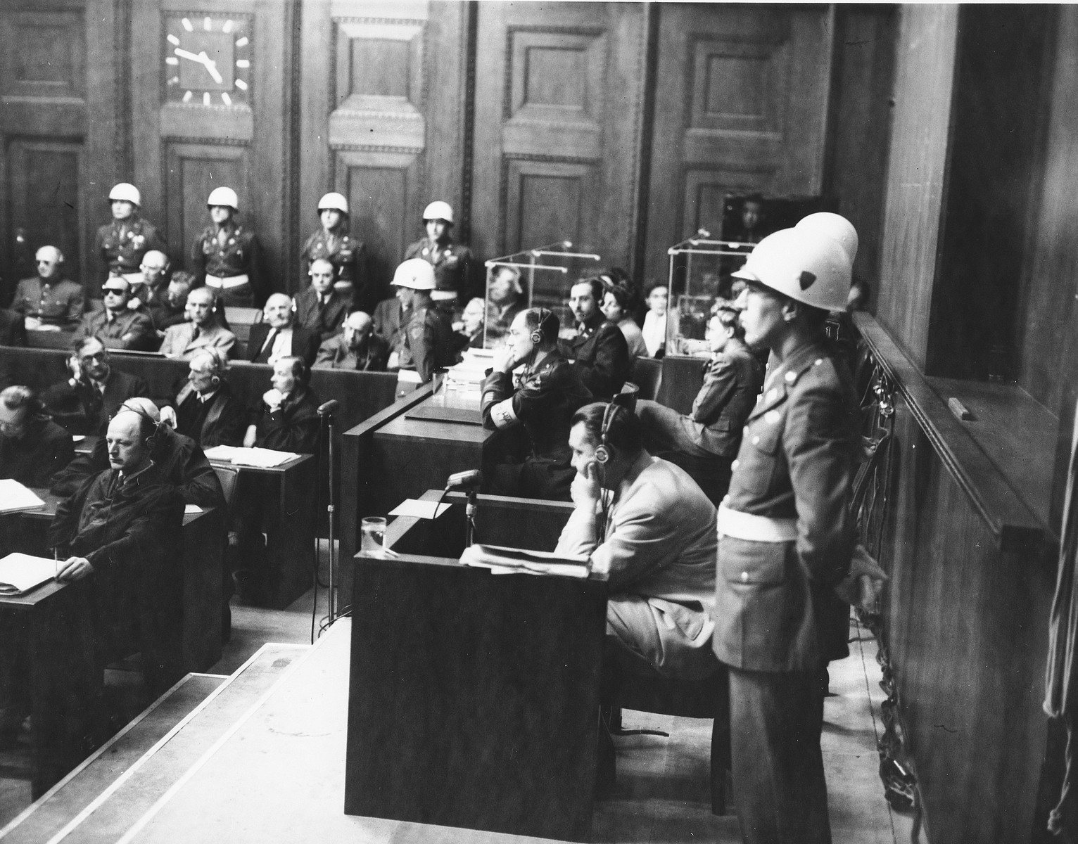 Hermann Goering sits in the witness stand with American Military policemen on either side during the International Military Tribunal in Nuremberg.

Standing in front is the donor, Albert Rose, an American military policeman.